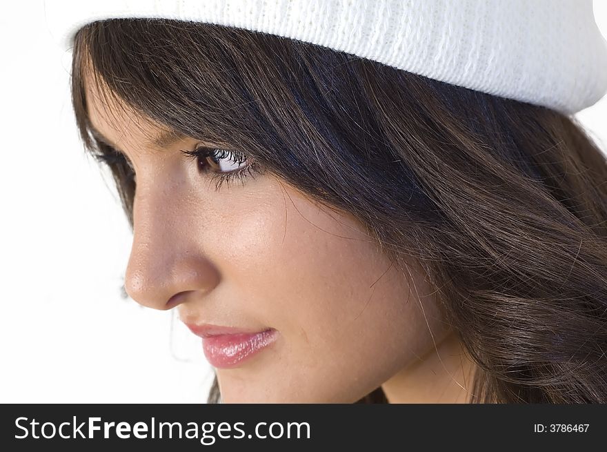 Portrait of young brunette girl with white hood. Winter clothing.