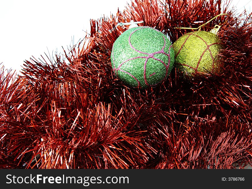 Two bauble balls in red tinsel isolated on a white background