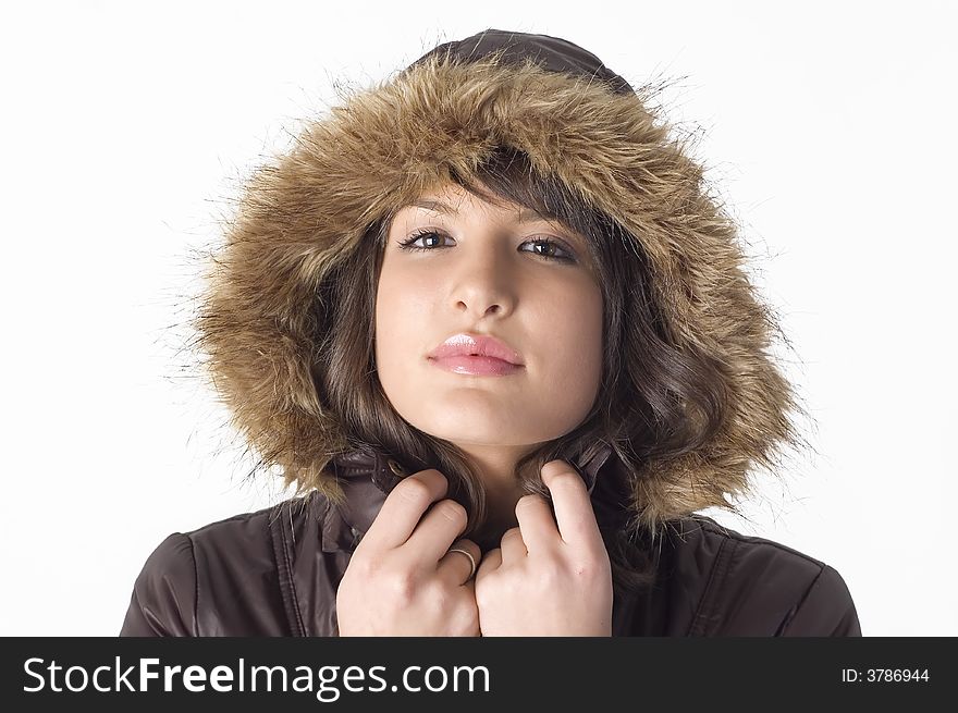 Young brunette girl in brown winter jacket.Happy face and worm look. Young brunette girl in brown winter jacket.Happy face and worm look.