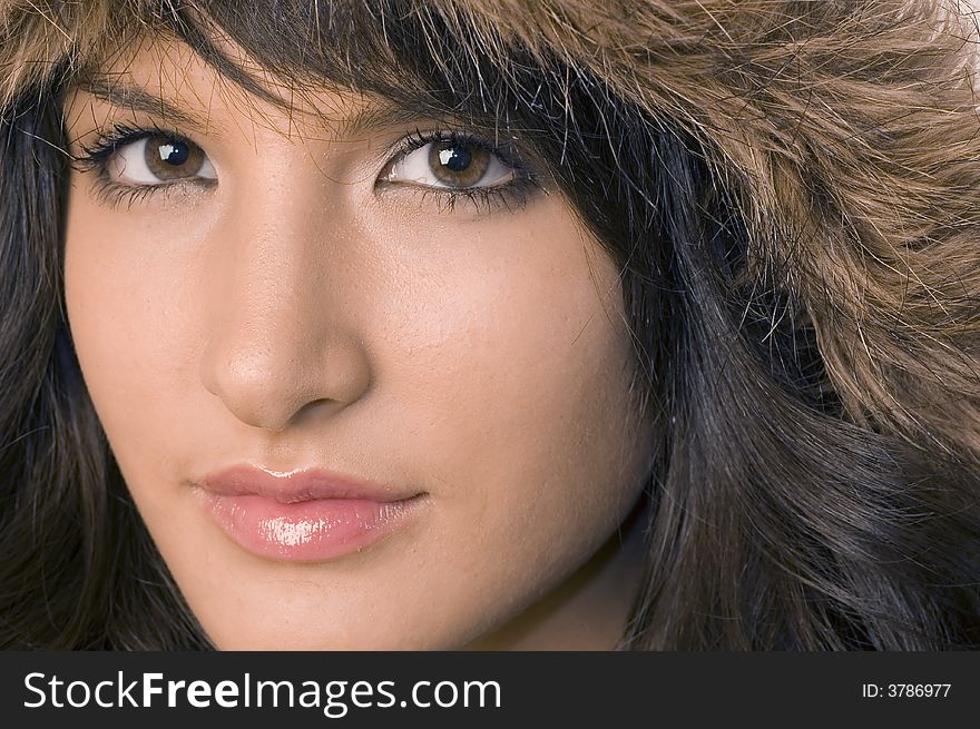 Young brunette girl in brown winter jacket.Happy face and worm look. Young brunette girl in brown winter jacket.Happy face and worm look.