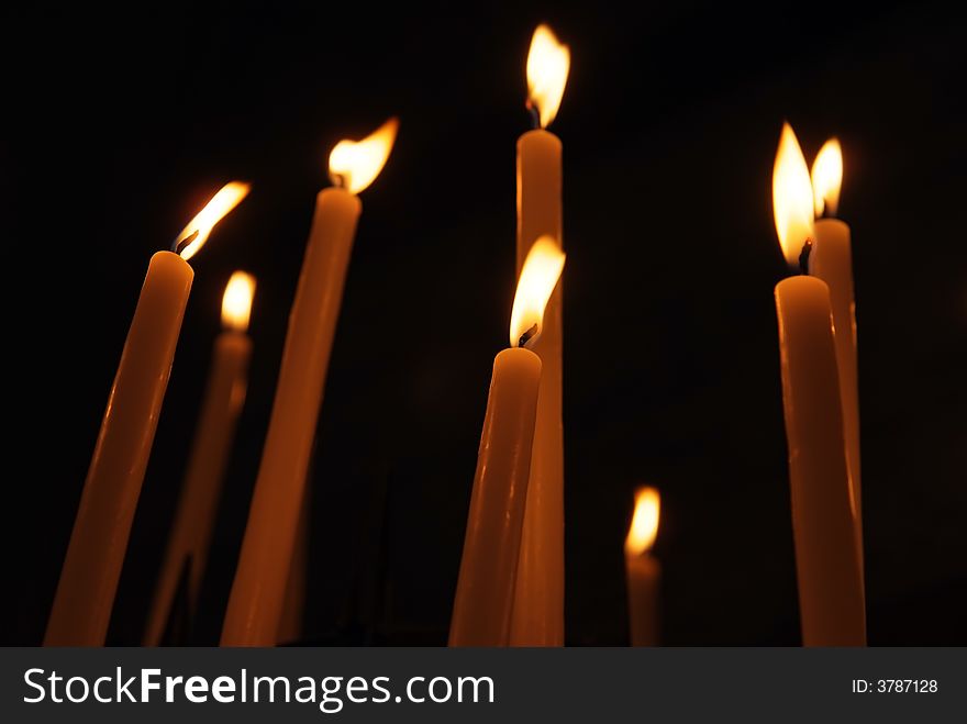 Some candles in a church agains black background. Some candles in a church agains black background