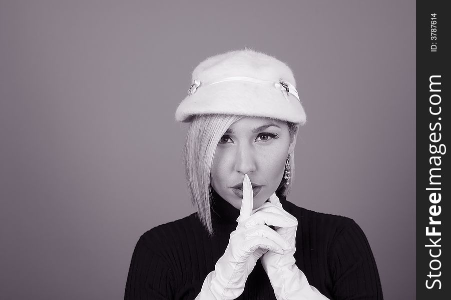 A blonde model in white hat and gloves in black and white. A blonde model in white hat and gloves in black and white