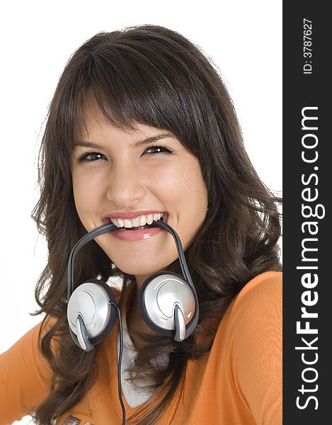 Young angry brunette girl with headphones in mouth. Young angry brunette girl with headphones in mouth.
