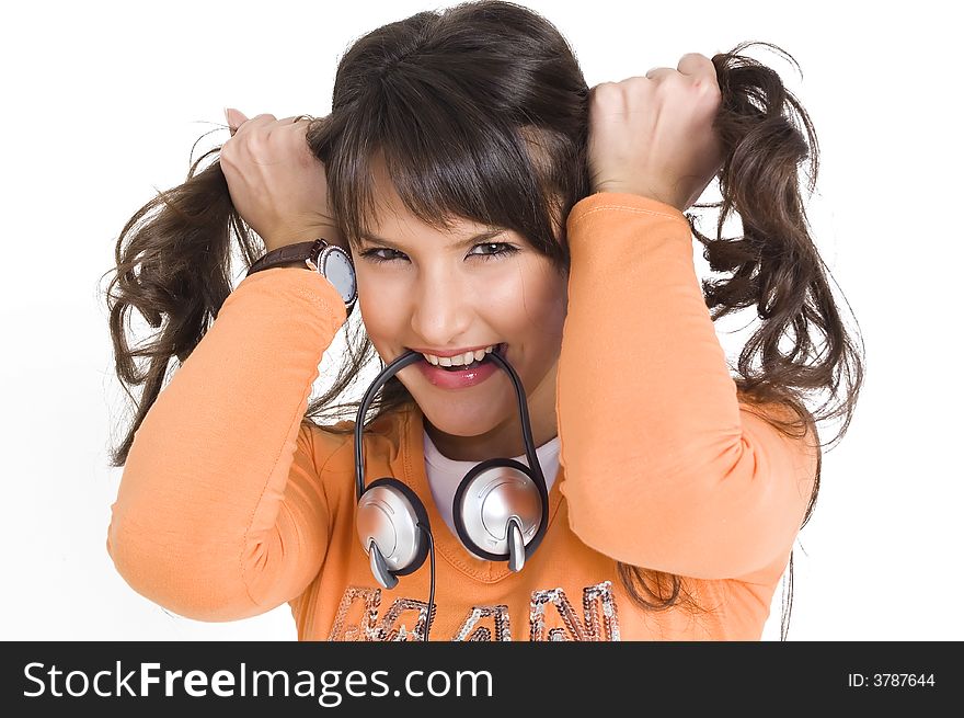 Young brunette girl with headphones in mouth making funny hair style. Young brunette girl with headphones in mouth making funny hair style.