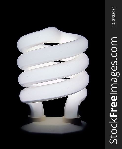 Compact fluorescent light bulb isolated on black background