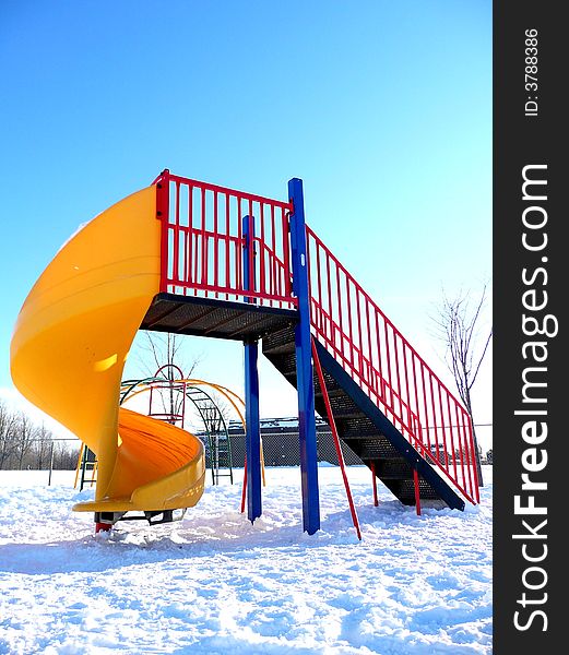 Children's playground covered in snow and vacant. Children's playground covered in snow and vacant