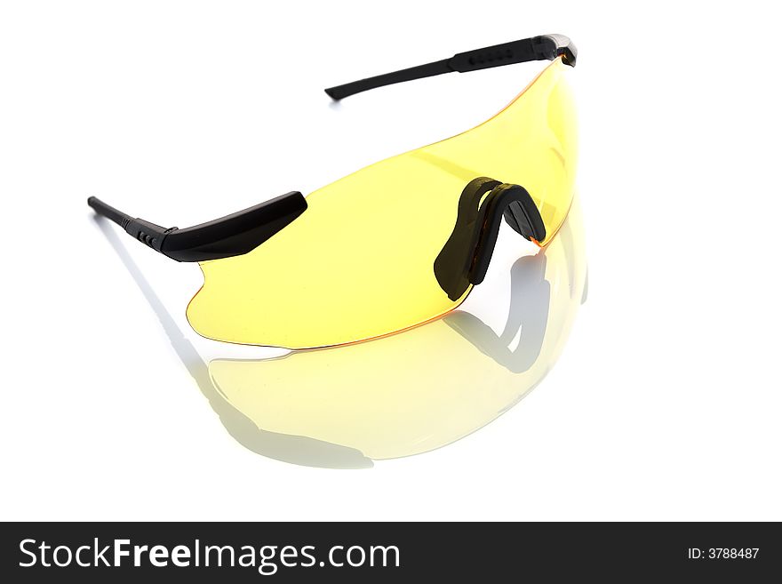 Yellow protective glasses isolated on white. Subtle reflection beneath.
