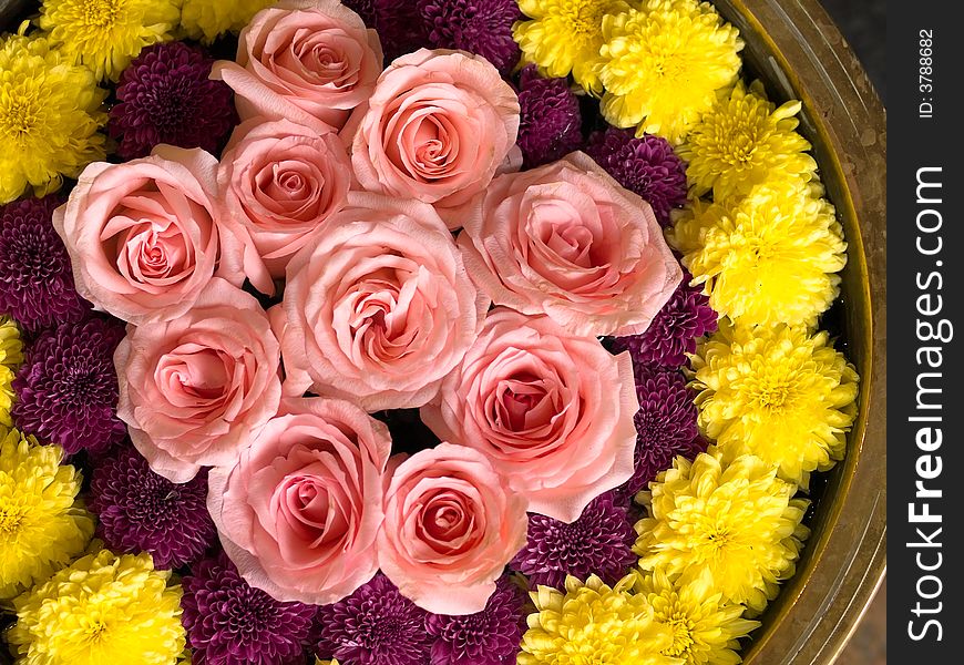 Cut flowers floating in a large bowl of water as part of an interior decoration. Cut flowers floating in a large bowl of water as part of an interior decoration