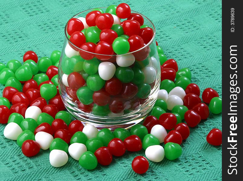 A glass filled with colorful Christmas candy.