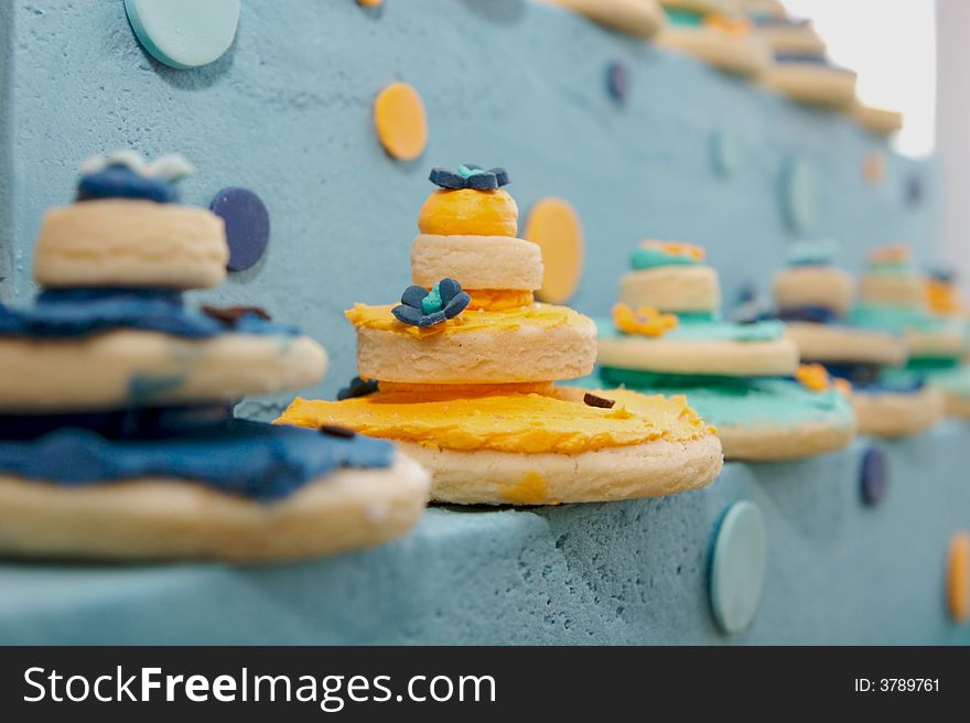 Up close decorated cookies on top of a gourmet cak