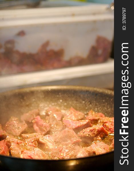 Image of beef tenderloin pieces grilling in a frying pan