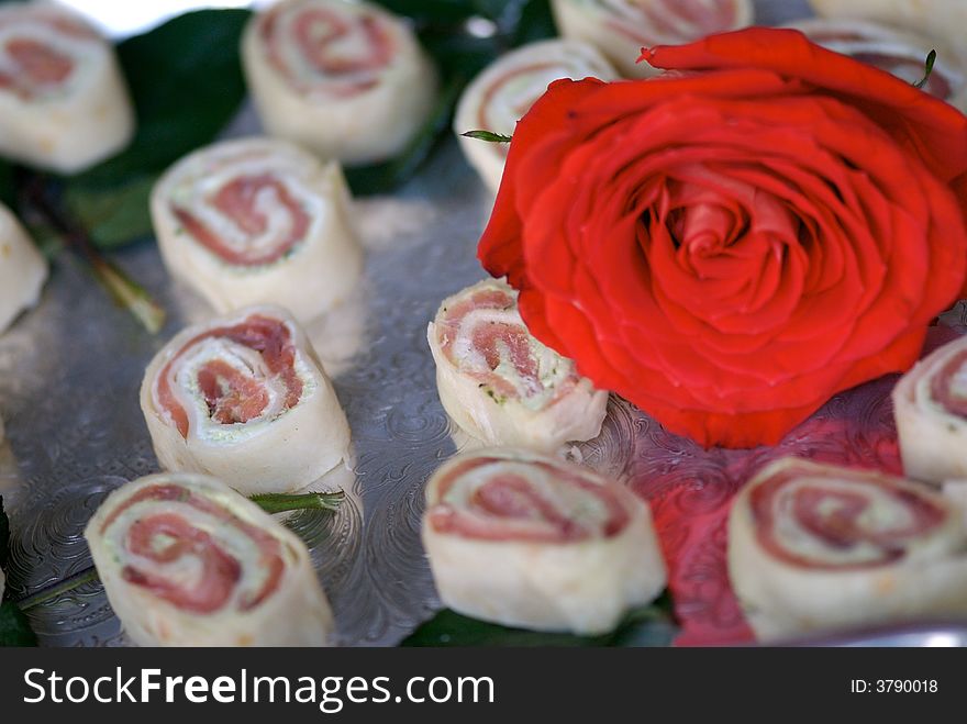 An image of delicious sushi appetizers with red rose