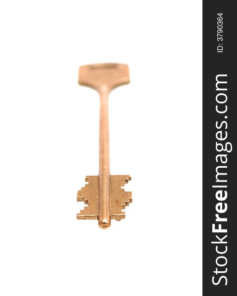 The gold key lays on a white background