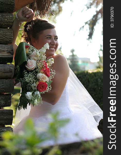 Young bride posing in park in the wedding day