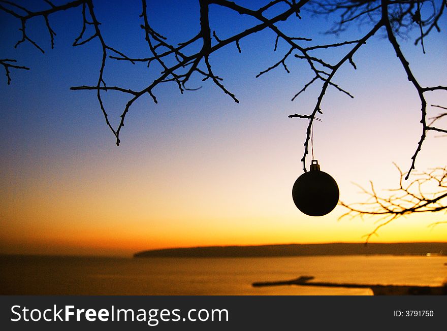 A Christmas ball with red and sunset background