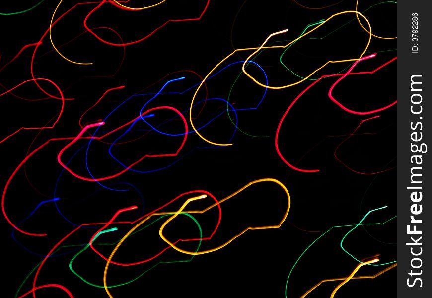 Abstraction of holiday lights in a swirling motion. Abstraction of holiday lights in a swirling motion.