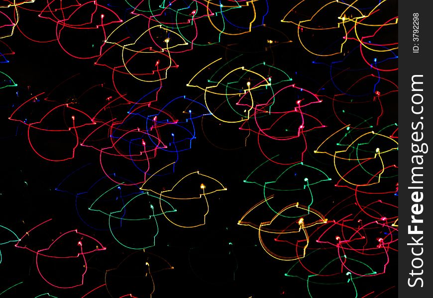 Many colored holiday lights moving around, creating a swirling motion. Many colored holiday lights moving around, creating a swirling motion.