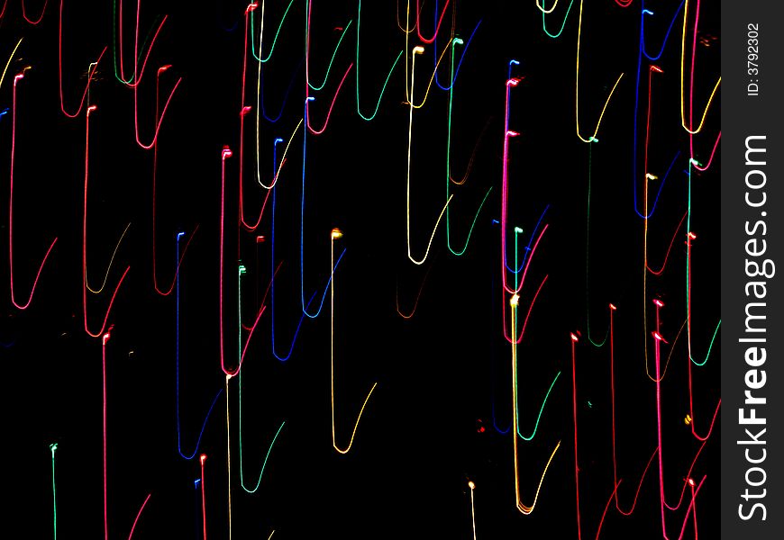 Lines of moving holiday lights against black background. Lines of moving holiday lights against black background.