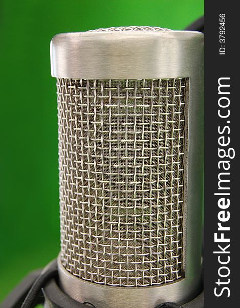 Studio silver steel microphone in green room. Studio silver steel microphone in green room