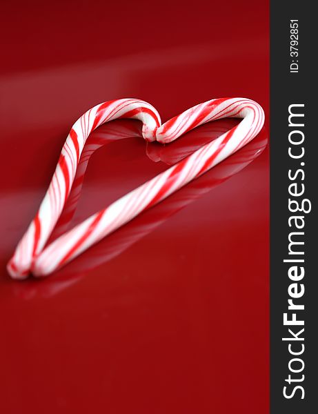 A candy cane heart on a red background. A candy cane heart on a red background