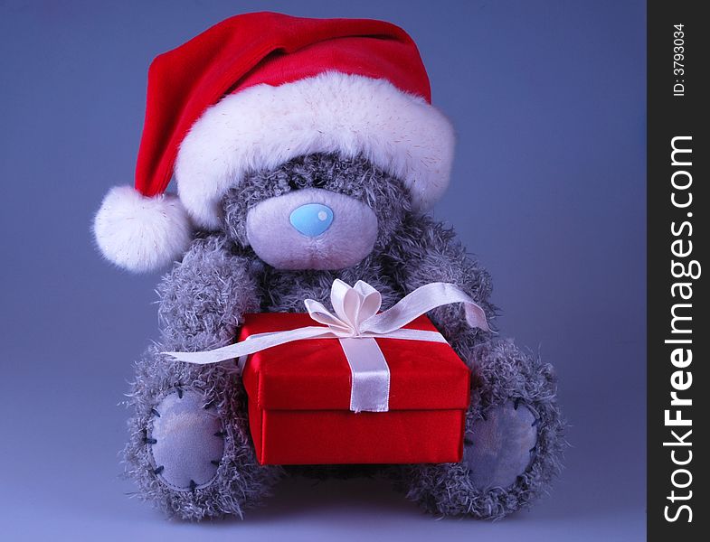 Cute Santa bear in red hat with gift. Cute Santa bear in red hat with gift