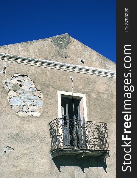 Old house with balcony in wrought iron