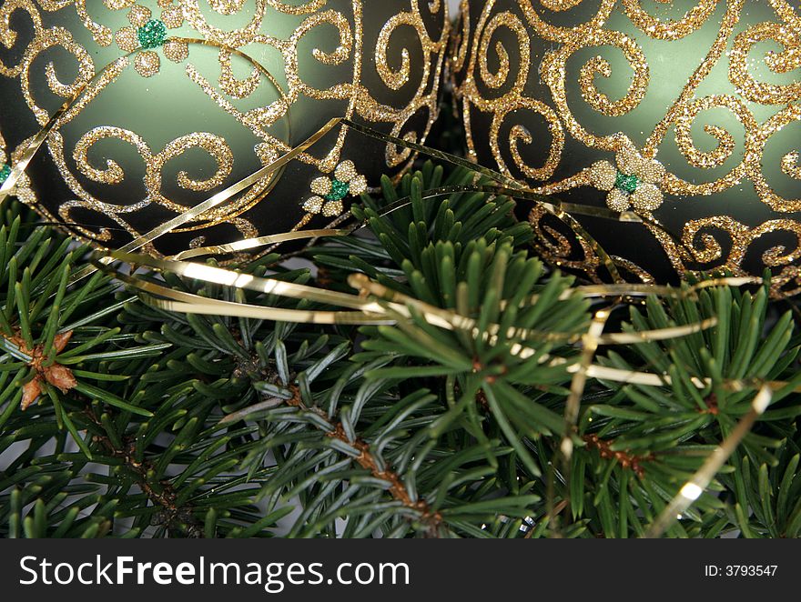 Christmas balls with gold ornament on the green pine branches. Christmas balls with gold ornament on the green pine branches