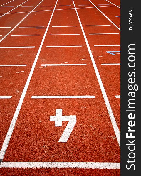 Number four of a racetrack, on red tarmac, for runners. Leading lines. Number four of a racetrack, on red tarmac, for runners. Leading lines