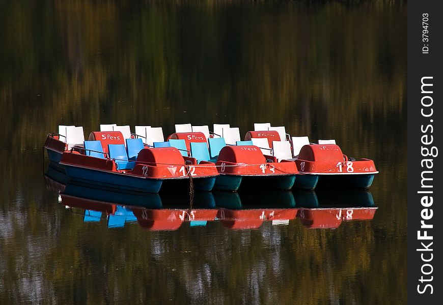 A couple of pedalo boats on a river in Germany. A couple of pedalo boats on a river in Germany