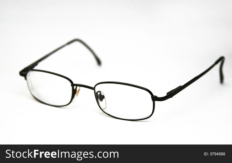Glasses in a black frame on a white background