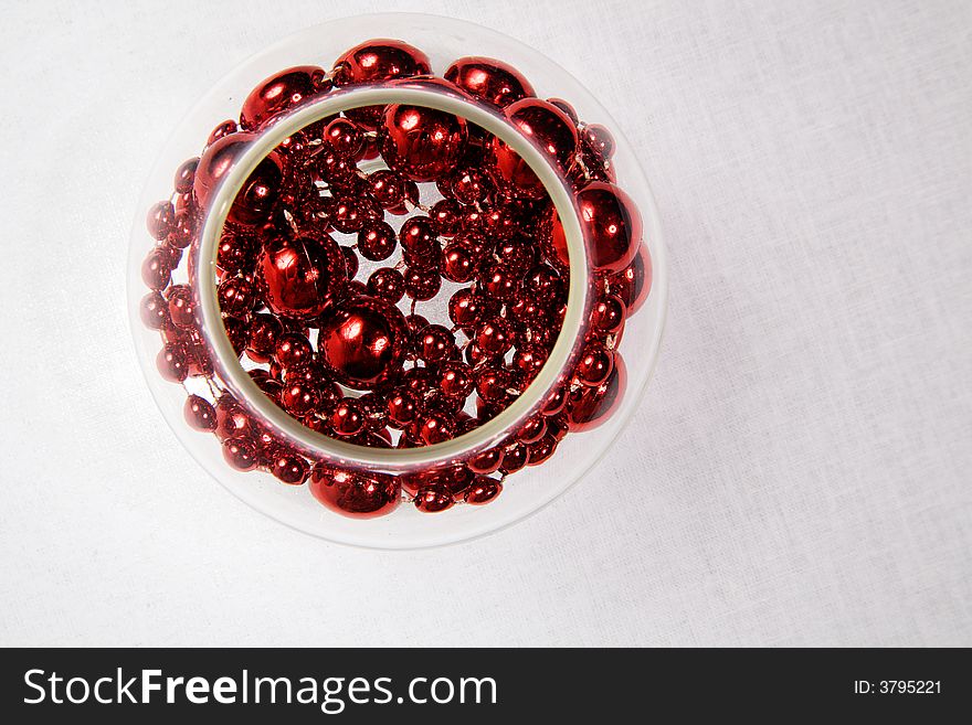 Glass bowl with a red necklace inside. Glass bowl with a red necklace inside