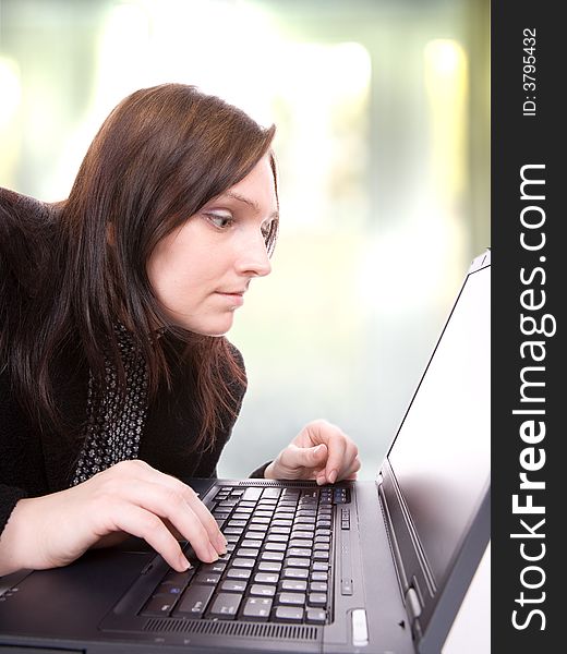 Young woman looks at her laptop