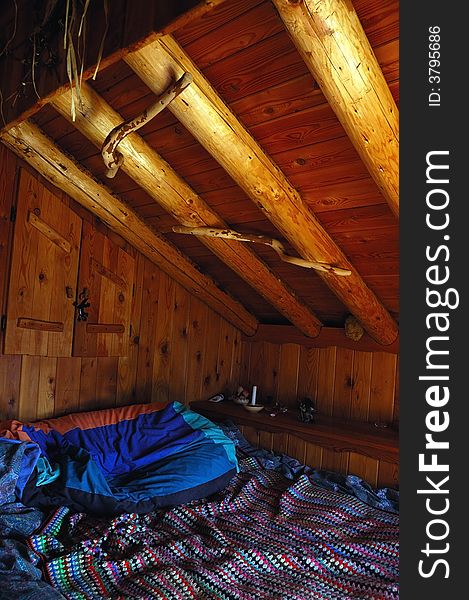 Interior view of a mountain cottage: the simple sleeping room. Interior view of a mountain cottage: the simple sleeping room