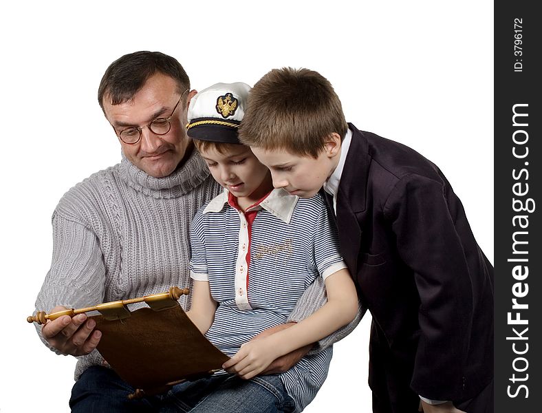 Studio. Isolated. The man shows a map and tells to boys about the far countries and travel. Studio. Isolated. The man shows a map and tells to boys about the far countries and travel