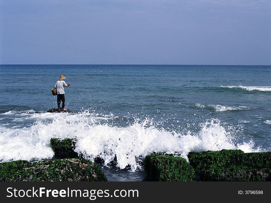 Fisher Man working in a Sea, in China. Fisher Man working in a Sea, in China.