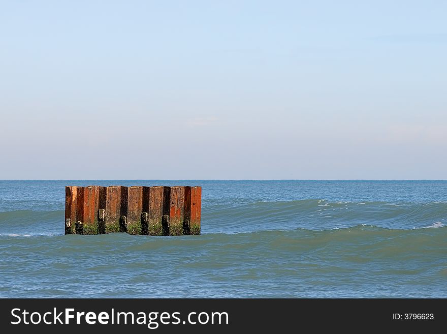 A metal barrier on the beach