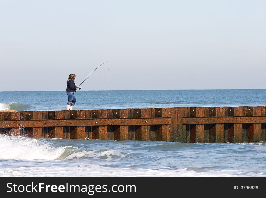 A women fishing in the ocean