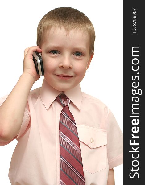 The nice boy speaks by phone on a white background