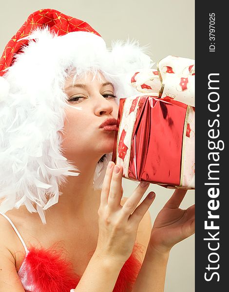Beautiful young woman wearing santa hat with gift. Beautiful young woman wearing santa hat with gift