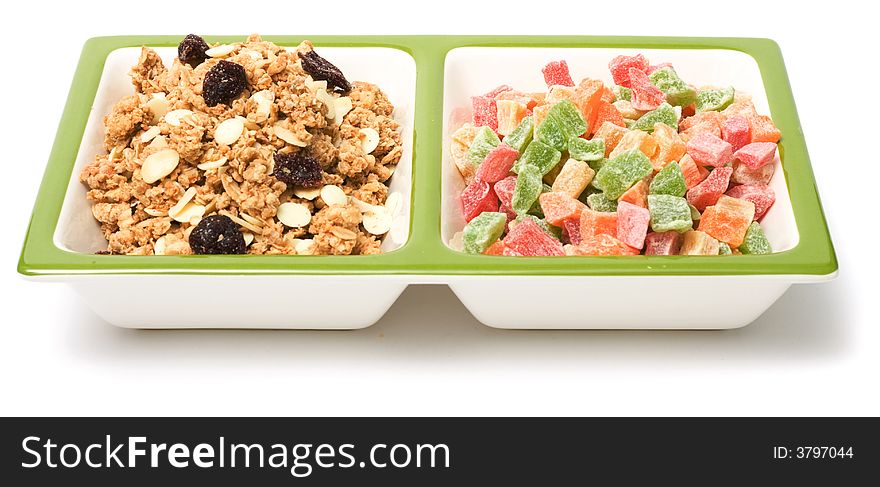 Muesli and candied fruits on white background. Healthy food image series