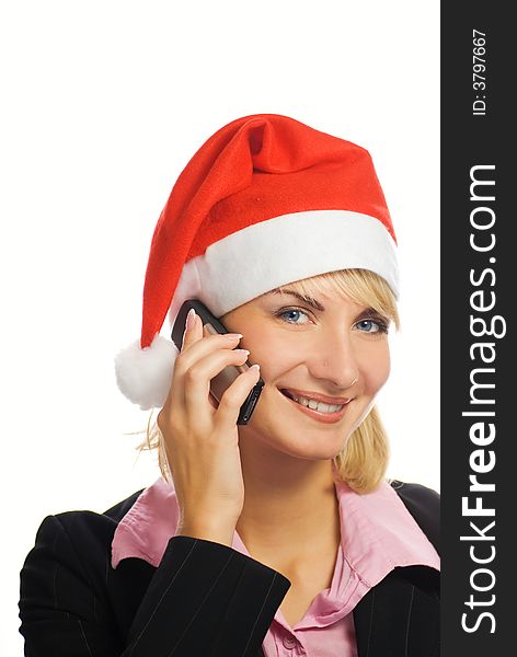 Business woman in Christmas hat talks on the phone. Isolated on white background