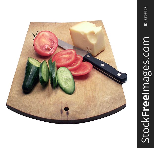 Tomato and cucumber with cheese and kitchen knife on wooden plate on white background. Tomato and cucumber with cheese and kitchen knife on wooden plate on white background