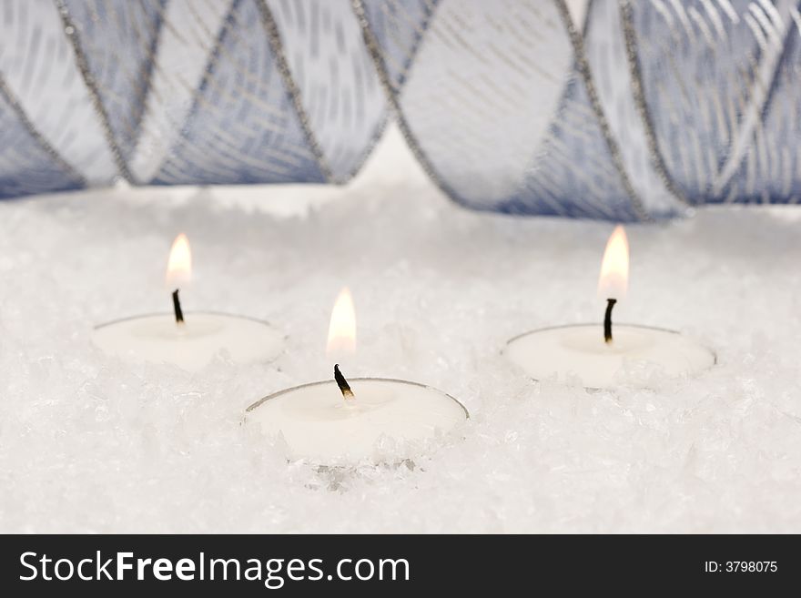 Festive new-year candles with snow