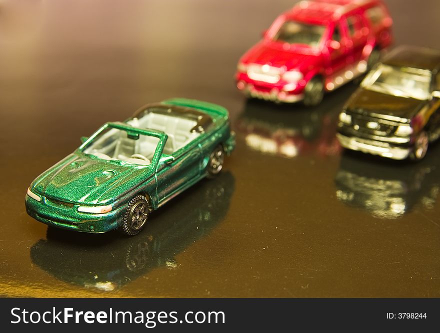 Toy cars on a reflective surface. Toy cars on a reflective surface