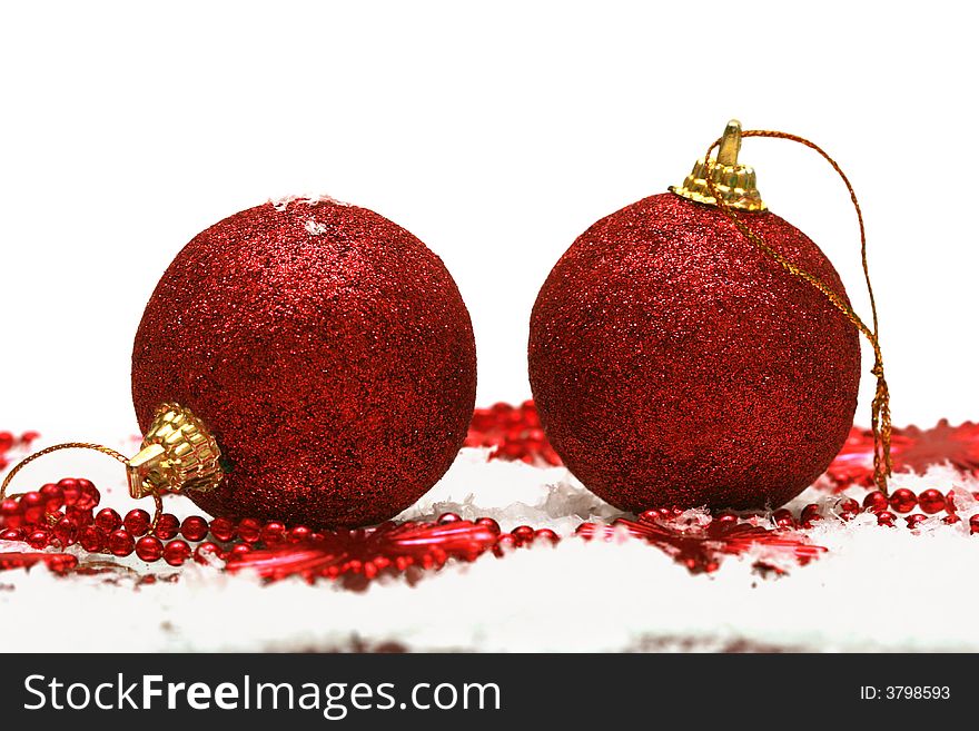 Red Christmas balls on snow background
