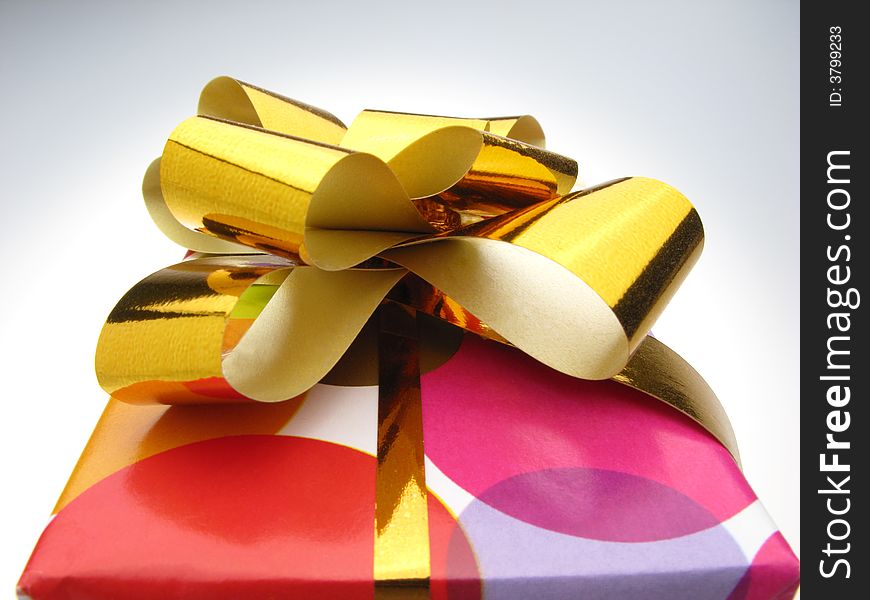 Gift in box packed into bright color paper