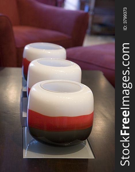 A row of red and white candles on a coffee table