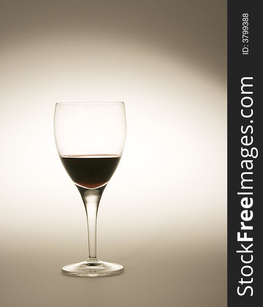 Wine glass filled with red wine with special lighting