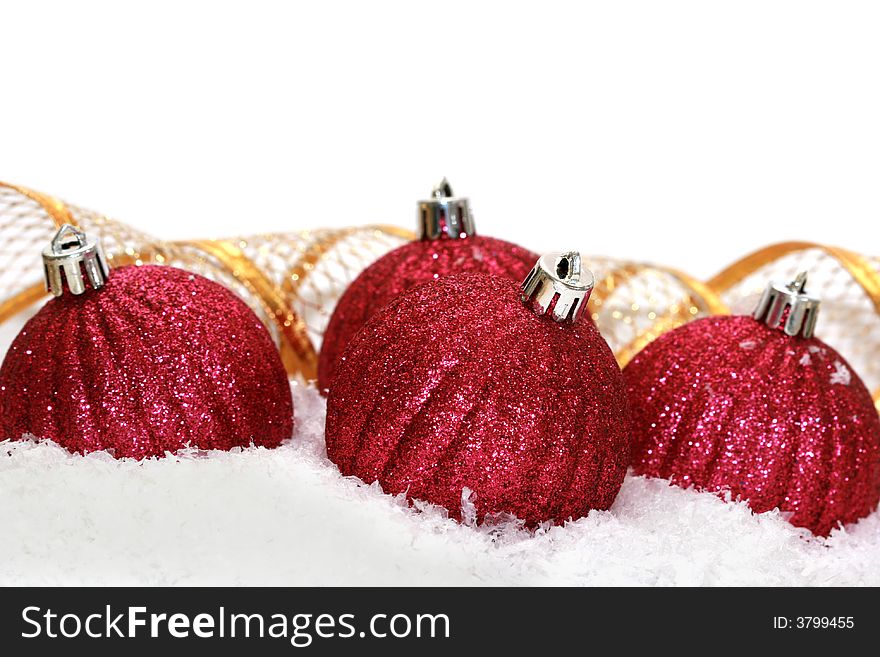 Red Christmas balls on snow background