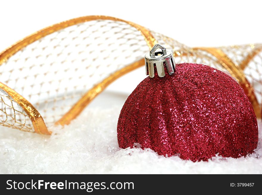 Red Christmas ball on snow background